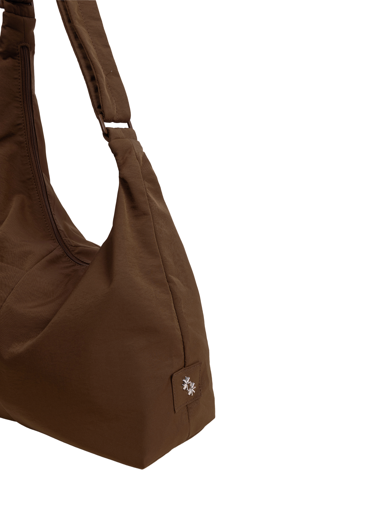 Close-up of the Midi Arc hobo-style bag in chocolate brown nylon, showing metal logo emblem