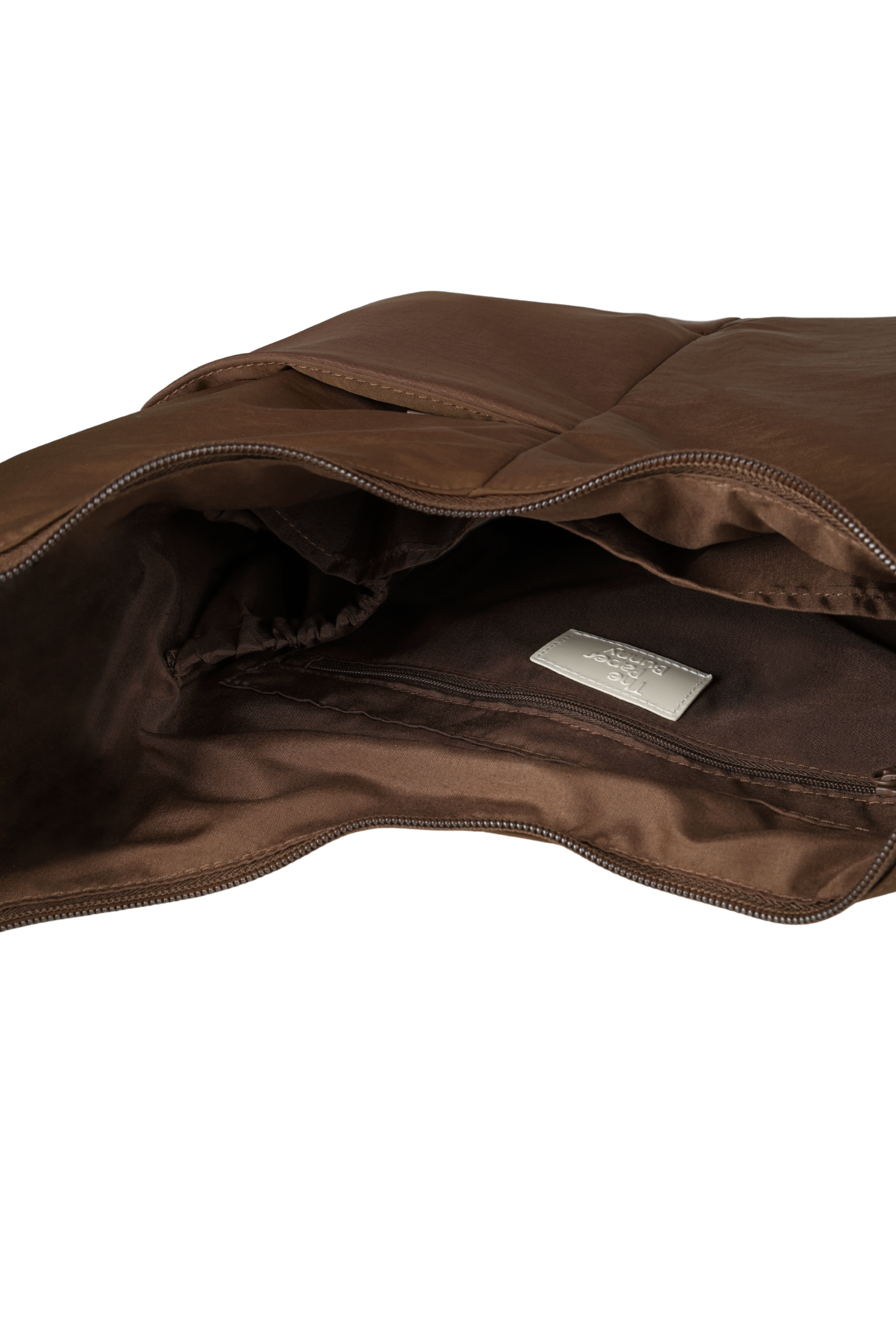 Interior of the Midi Arc hobo-style bag in chocolate brown nylon, with multiple pockets and a bottle holder